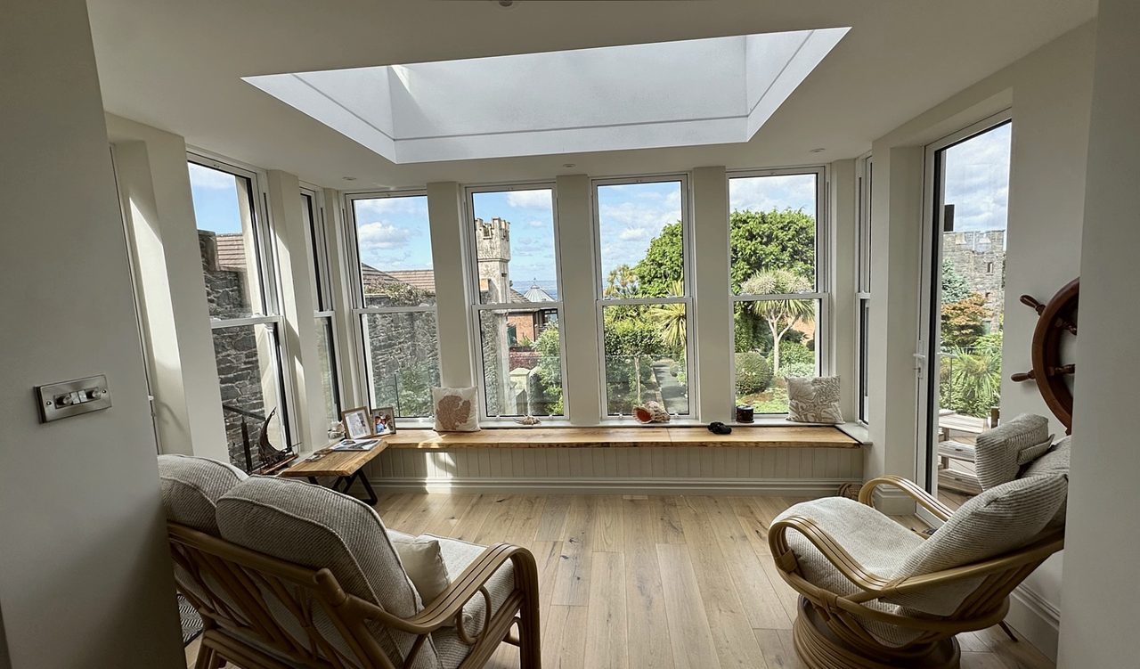 Interior with a roof lantern, armchairs and windows on three sides