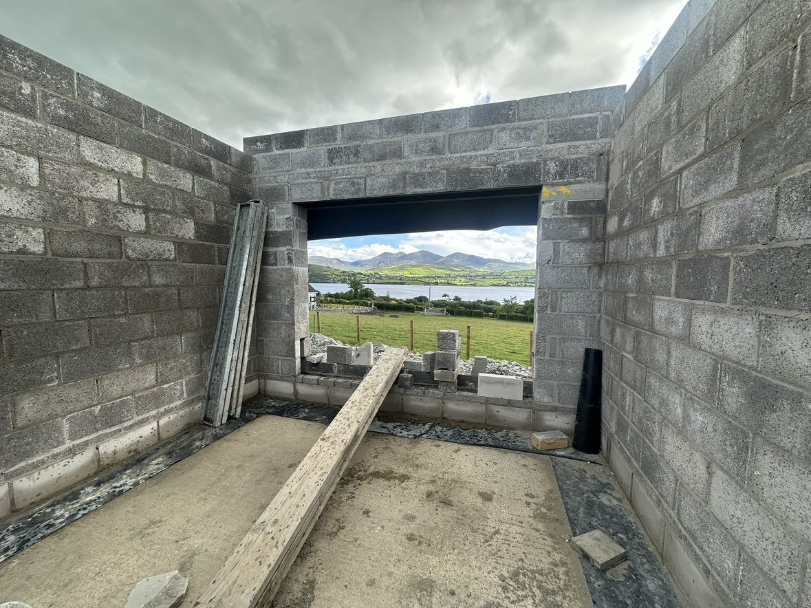 New blockwork walls with a wide opening toward the mountains